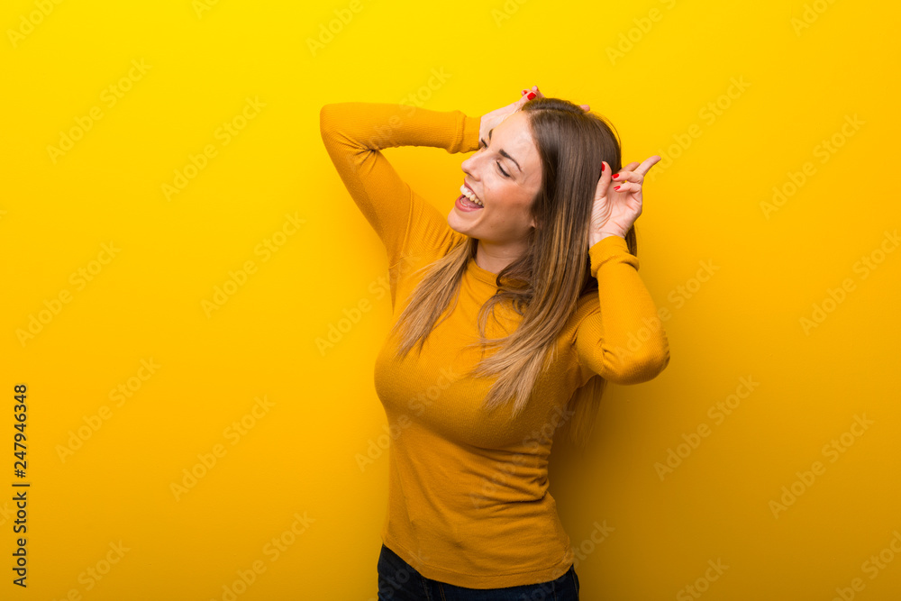 Young woman on yellow background makes funny and crazy face emotion Young woman on yellow background makes funny and crazy face emotion