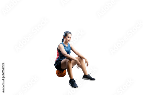 Pretty asian basketball player woman sitting on the basketball