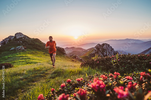 Man trail running on a mountain at the dask