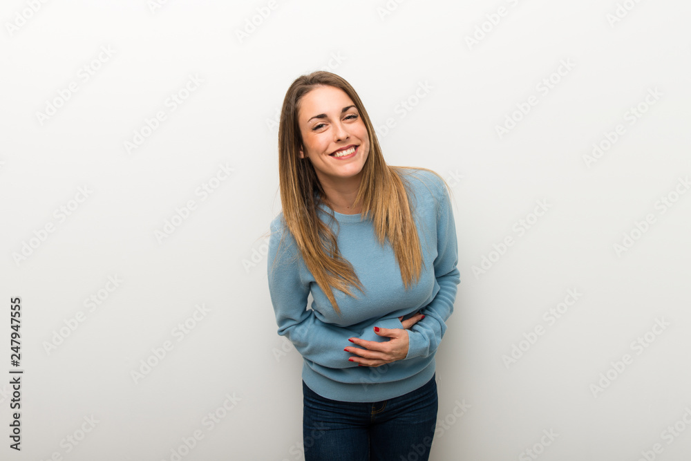 Blonde woman on isolated white background keeping the arms crossed while smiling Blonde woman on isolated white background keeping the arms crossed while smiling