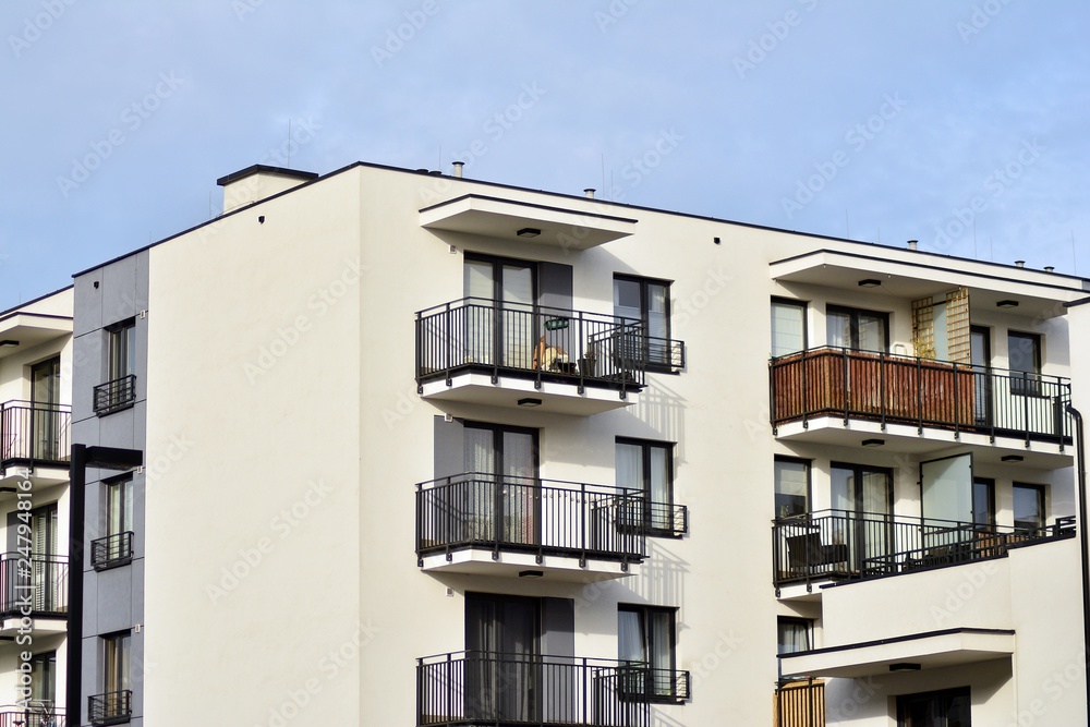 Modern apartment buildings on a sunny day with a blue sky. Facade of a modern apartment building Modern apartment buildings on a sunny day with a blue sky. Facade of a modern apartment building