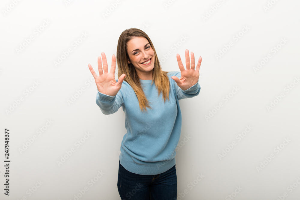 Blonde woman on isolated white background counting ten with fingers Blonde woman on isolated white background counting ten with fingers