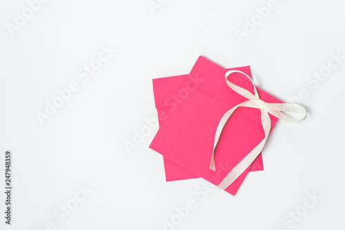 red envelope with yellow ribbon in the shape of a bow for CD, vertical position . square envelope