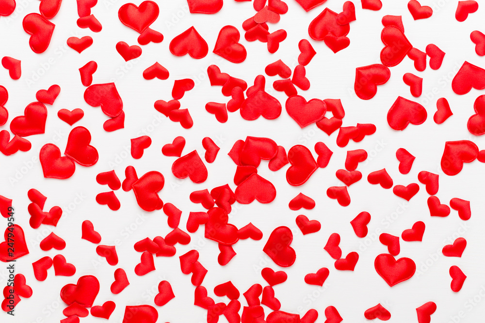 Valentines day background red hearts on white wooden background.