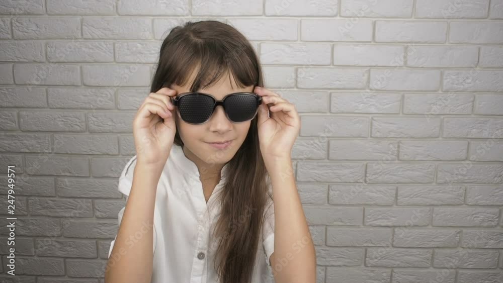 Child wearing pinhole glasses. Little girls in glasses for training eyes. Child wearing pinhole glasses. Little girls in glasses for training eyes.
