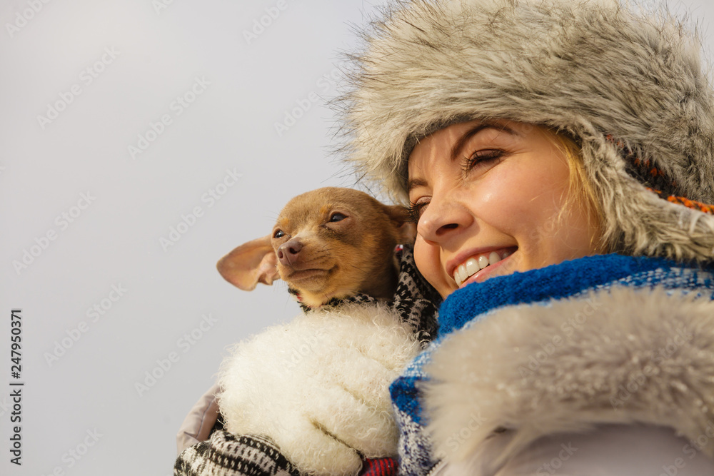 Woman hug warming her dog in cold day Woman hug warming her dog in cold day
