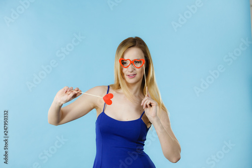 Woman holding carnival accessoies on stick photo