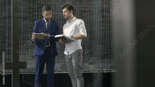 Two businessmen talking about corporate topics.