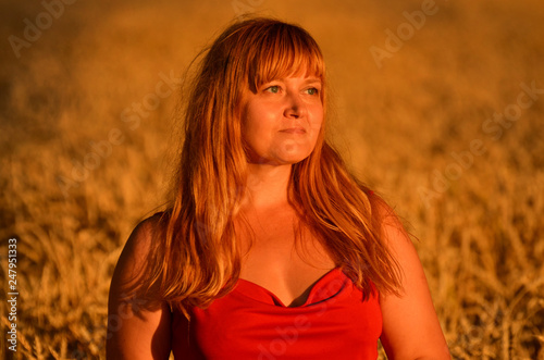 Woman in red dress watching the sunset