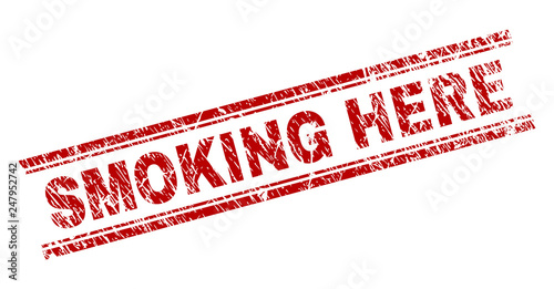 SMOKING HERE seal print with corroded texture. Red vector rubber print of SMOKING HERE text with dust texture. Text caption is placed between double parallel lines.