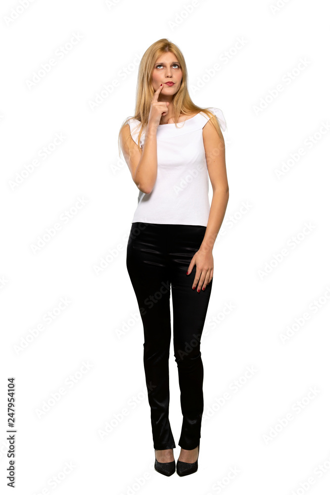 Young blonde woman smiling and looking to the front with confident face over isolated white background Young blonde woman smiling and looking to the front with confident face over isolated white background