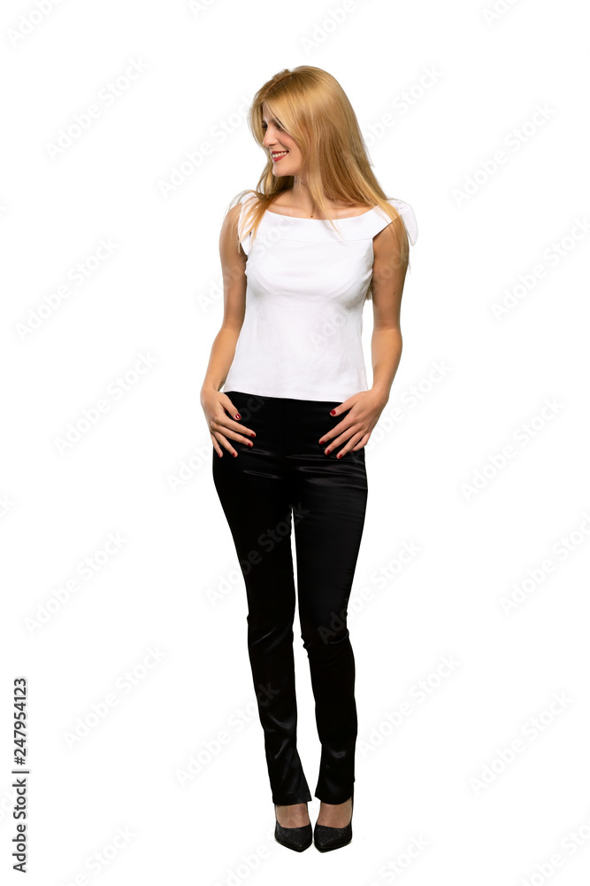 Young blonde woman looking to the side with the hand on the chin over isolated white background Young blonde woman looking to the side with the hand on the chin over isolated white background