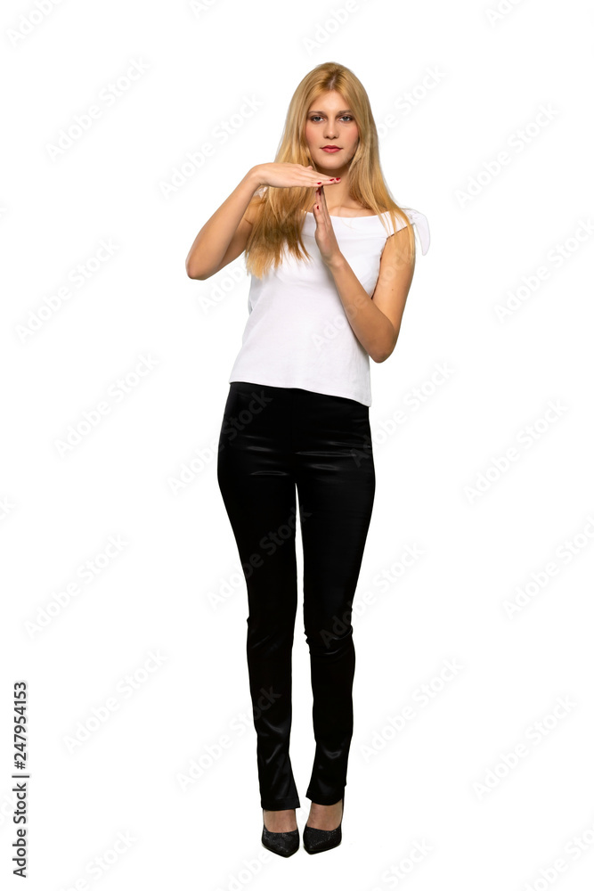 Young blonde woman making stop gesture with her hand to stop an act over isolated white background Young blonde woman making stop gesture with her hand to stop an act over isolated white background