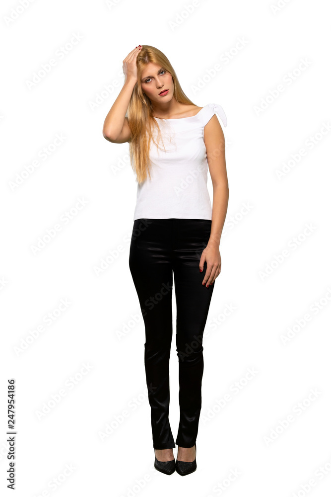 Young blonde woman takes hands on head because has migraine over isolated white background Young blonde woman takes hands on head because has migraine over isolated white background