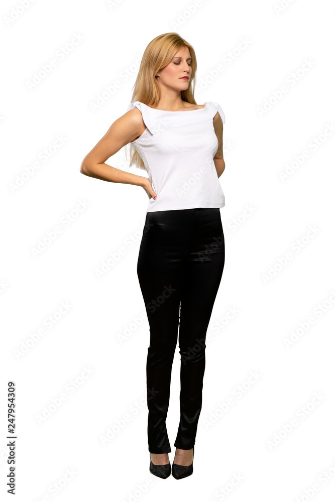 Young blonde woman suffering from backache for having made an effort over isolated white background Young blonde woman suffering from backache for having made an effort over isolated white background