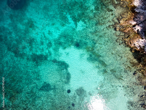 top view of rocky shore crystal clear Adriatic Sea, drone shot