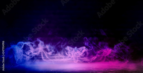 Background of an empty dark room. Empty walls, neon light, smoke, smog. Blue and pink smoke, ultraviolet light in the dark.