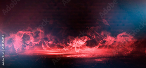 Red Smoke on a dark background. Dark empty room with rays of light  searchlight. Color correction  background.