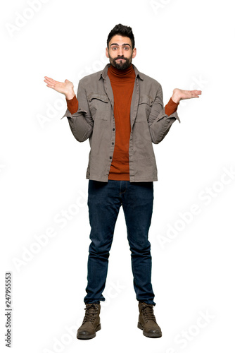 Full-length shot of Handsome man with beard having doubts while raising hands and shoulders on isolated white background