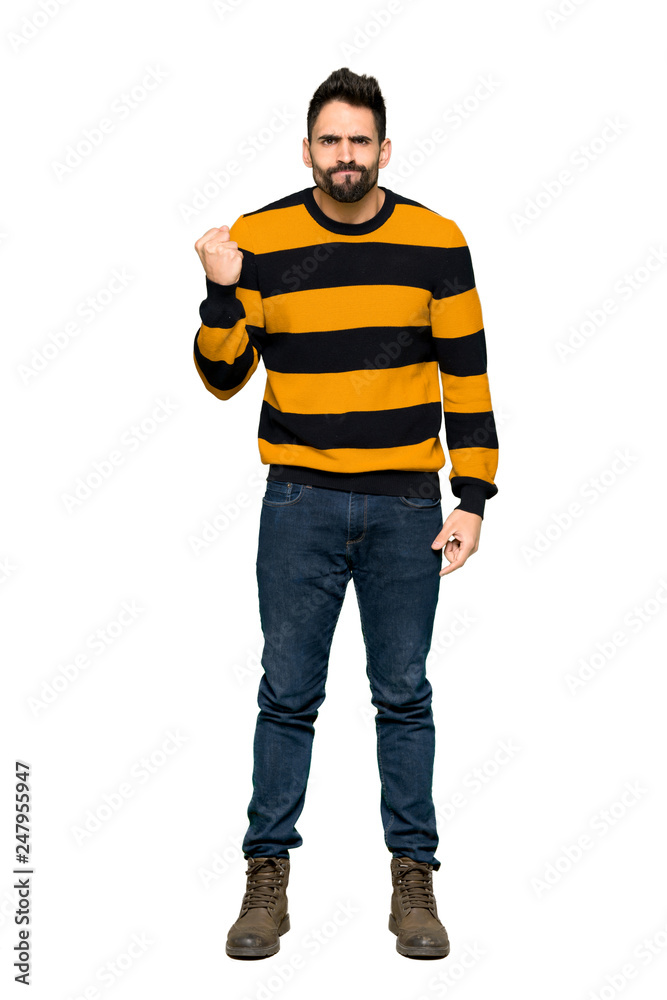 Full-length shot of Handsome man with striped sweater with angry gesture on isolated white background Full-length shot of Handsome man with striped sweater with angry gesture on isolated white background