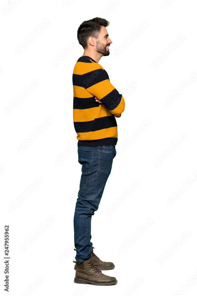 Full-length shot of Handsome man with striped sweater in lateral position on isolated white background Full-length shot of Handsome man with striped sweater in lateral position on isolated white background