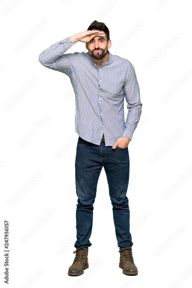 Full-length shot of Elegant man with shirt looking far away with hand to look something on isolated white background
