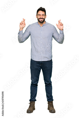 Full-length shot of Elegant man with shirt with fingers crossing and wishing the best on isolated white background