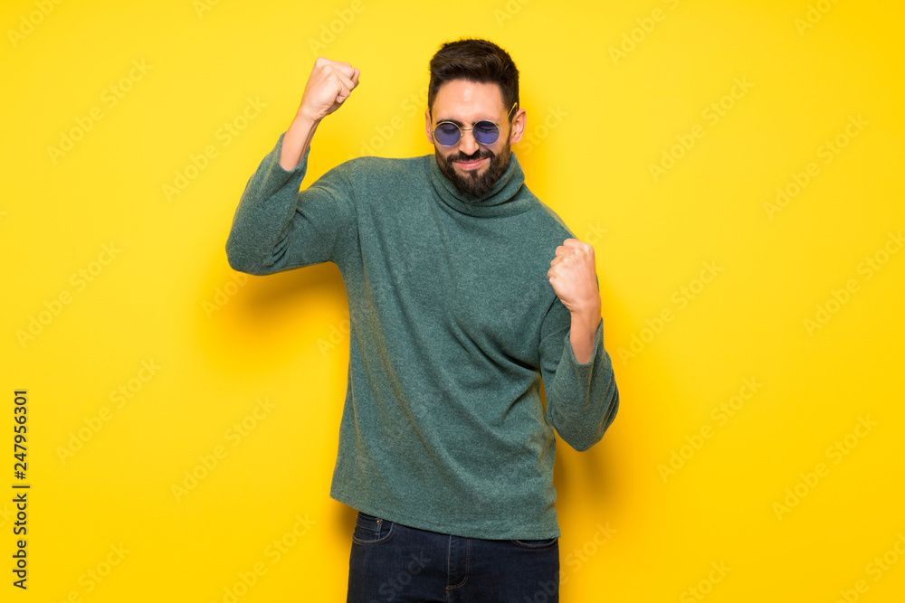 Handsome man with sunglasses celebrating a victory Handsome man with sunglasses celebrating a victory