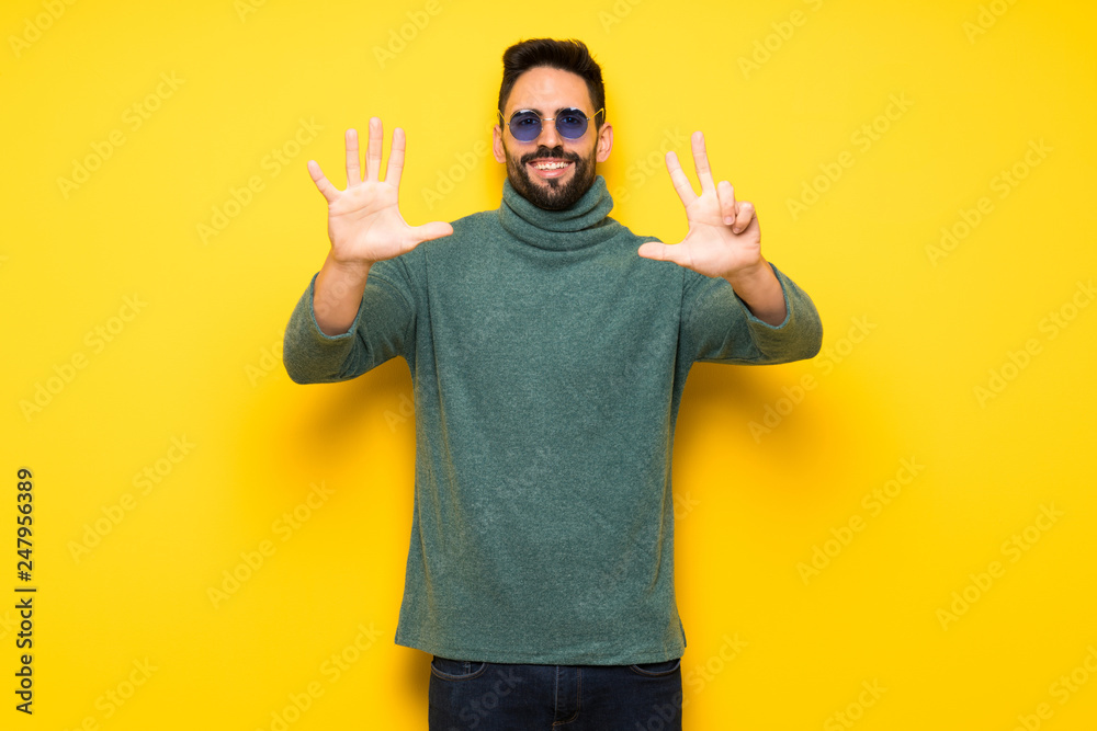 Handsome man with sunglasses counting eight with fingers