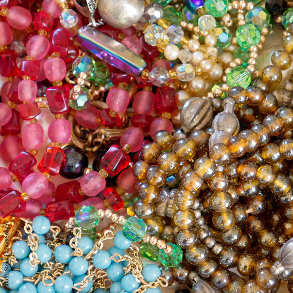 colorful gems and golden fashion jewels closeup, top view colorful gems and golden fashion jewels closeup, top view