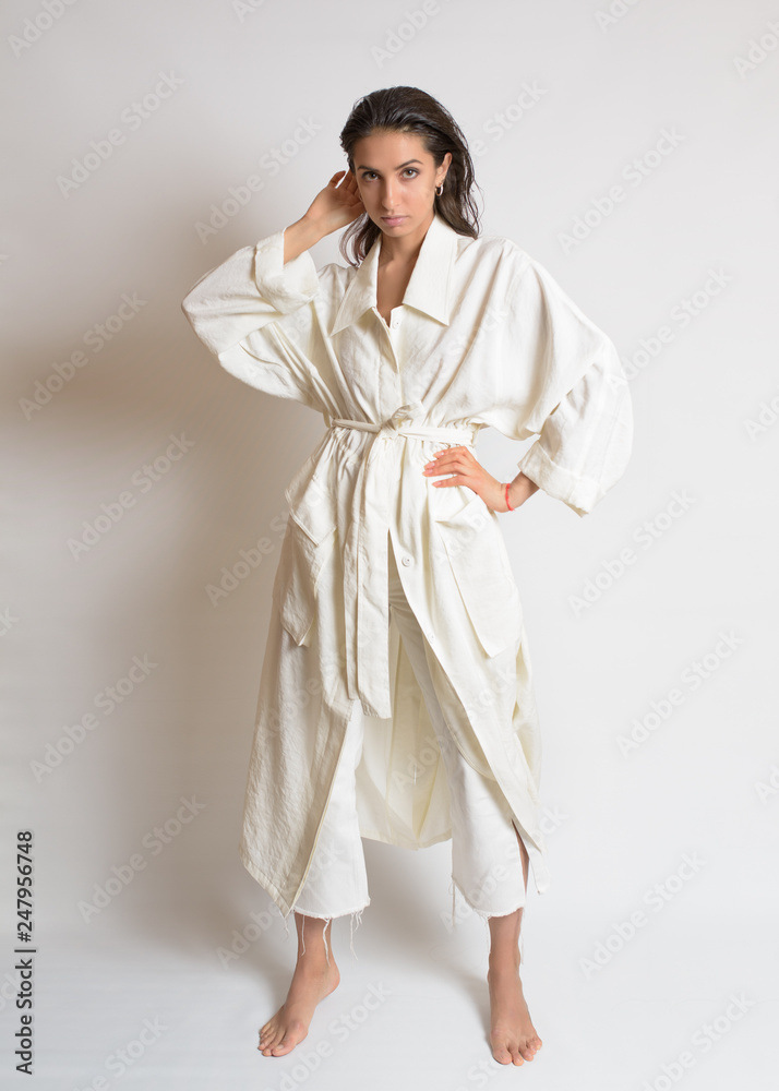 Beautiful woman in white dress or bathrobe with wet style hair on white background Beautiful woman in white dress or bathrobe with wet style hair on white background