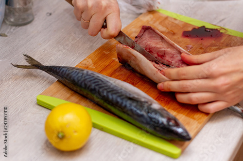 woman cooks fish