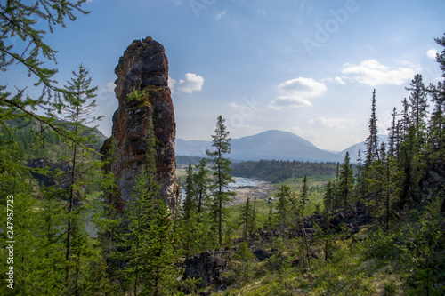 An excellent view of the nature monument of Stone Woman (Kamennaya Baba) and the valley of the Kozhim River in clear good weather. Yugyd va National Park, Subpolar Urals, Komi Republic, Russia photo