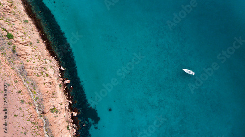 Sand, rock, and sea patterns on cristal clear waters.