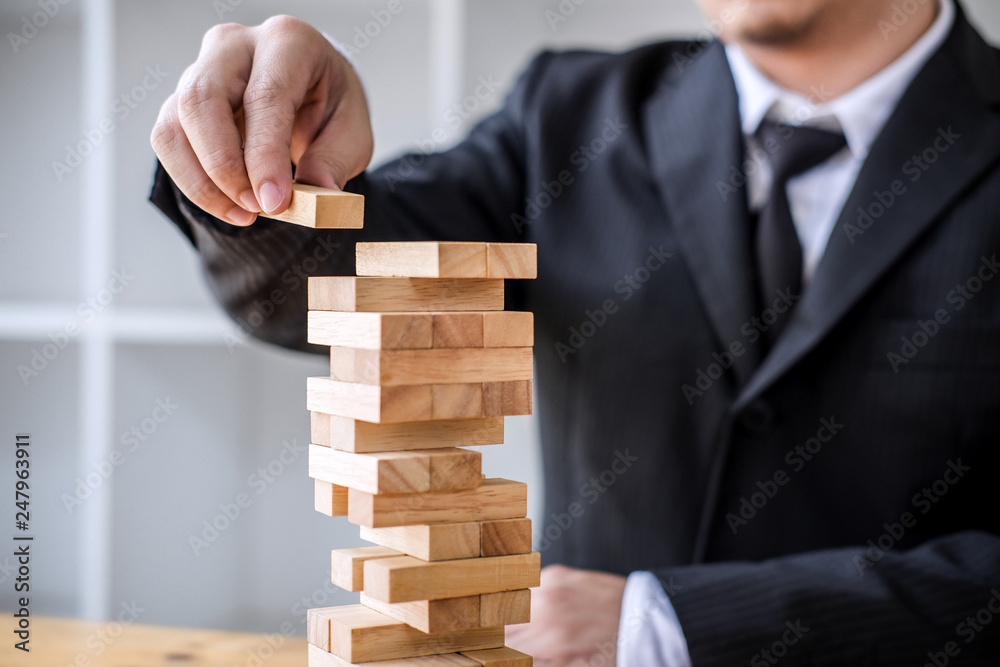 Alternative risk concept, plan and strategy in business, Risk To Make Business Growth Concept With Wooden Blocks, Images of hand of business people placing and pulling wood block on the tower Alternative risk concept, plan and strategy in business, Risk To Make Business Growth Concept With Wooden Blocks, Images of hand of business people placing and pulling wood block on the tower