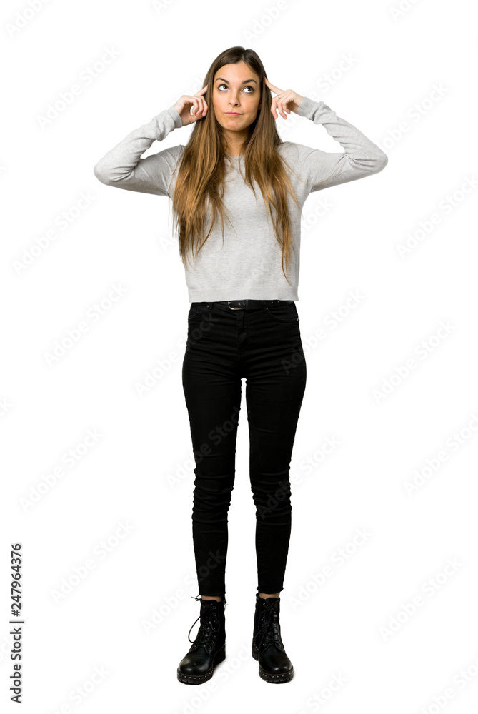 Full-length shot of young girl having doubts and thinking on isolated white background Full-length shot of young girl having doubts and thinking on isolated white background