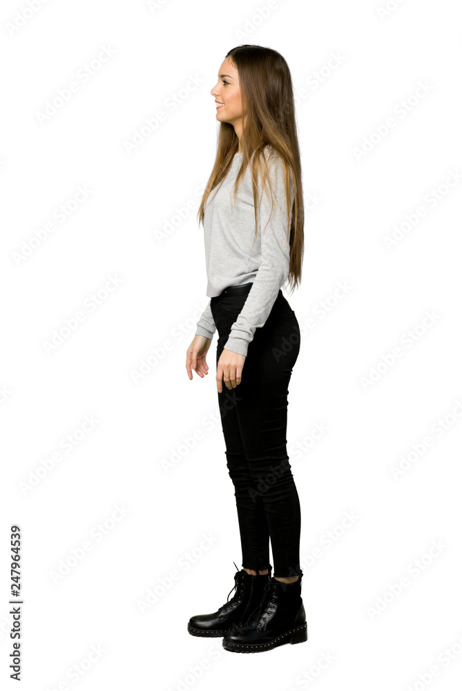 Obraz premium Full-length shot of young girl in lateral position on isolated white background