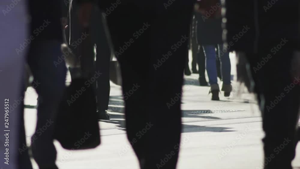 Slow motion shot of people carrying shopping bags, walking on the sunny sidewalk of a main street in an european city center on a sunny winters day. Slow motion shot of people carrying shopping bags, walking on the sunny sidewalk of a main street in an european city center on a sunny winters day.