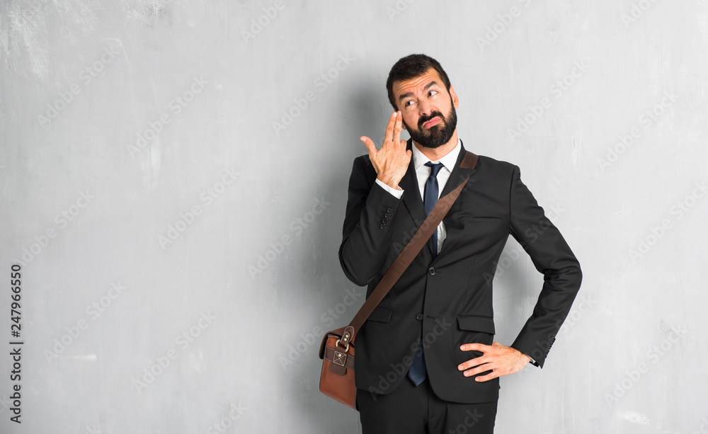 Businessman with beard with problems making suicide gesture Businessman with beard with problems making suicide gesture