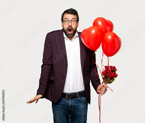 Man in valentine day with surprise and shocked facial expression over isolated grey background © luismolinero