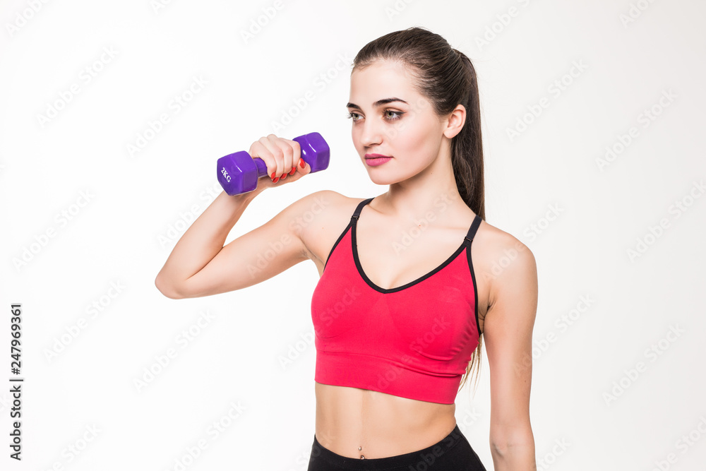 Sporty woman does the exercises with dumbbells on white background. Photo of muscular woman in sportswear on white background. Strength and motivation. Sporty woman does the exercises with dumbbells on white background. Photo of muscular woman in sportswear on white background. Strength and motivation.