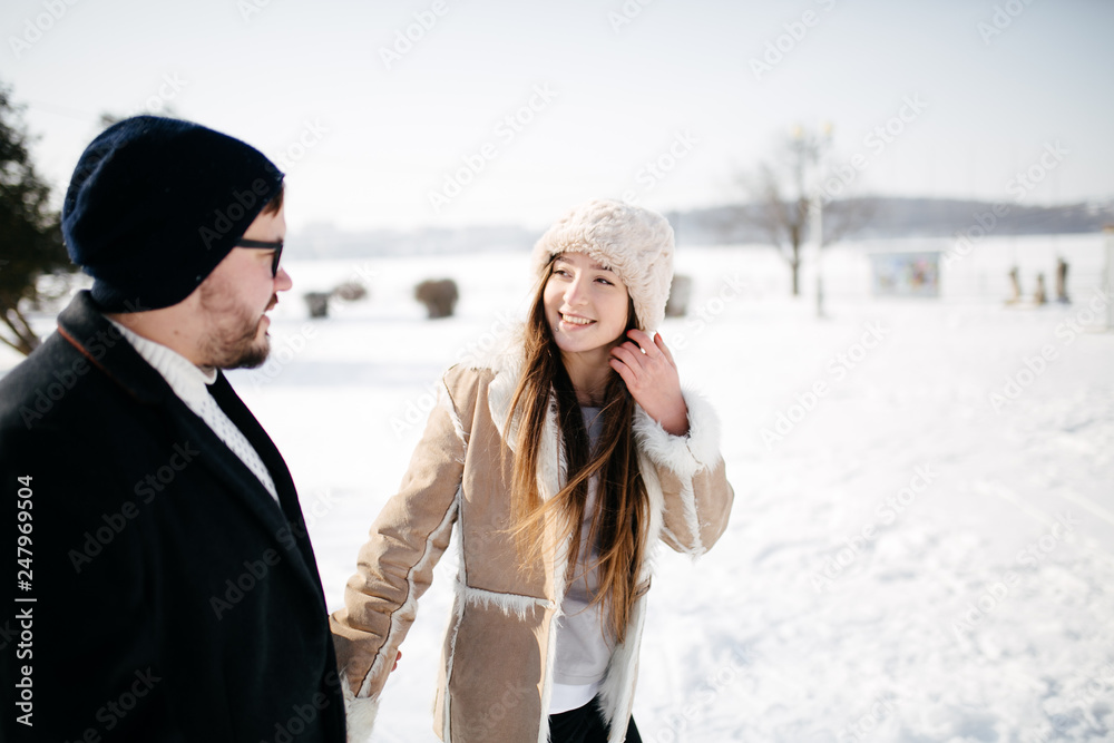 Young Beautiful Couple Taking Fun and Smiling Outdoors in Snowy Winter Young Beautiful Couple Taking Fun and Smiling Outdoors in Snowy Winter