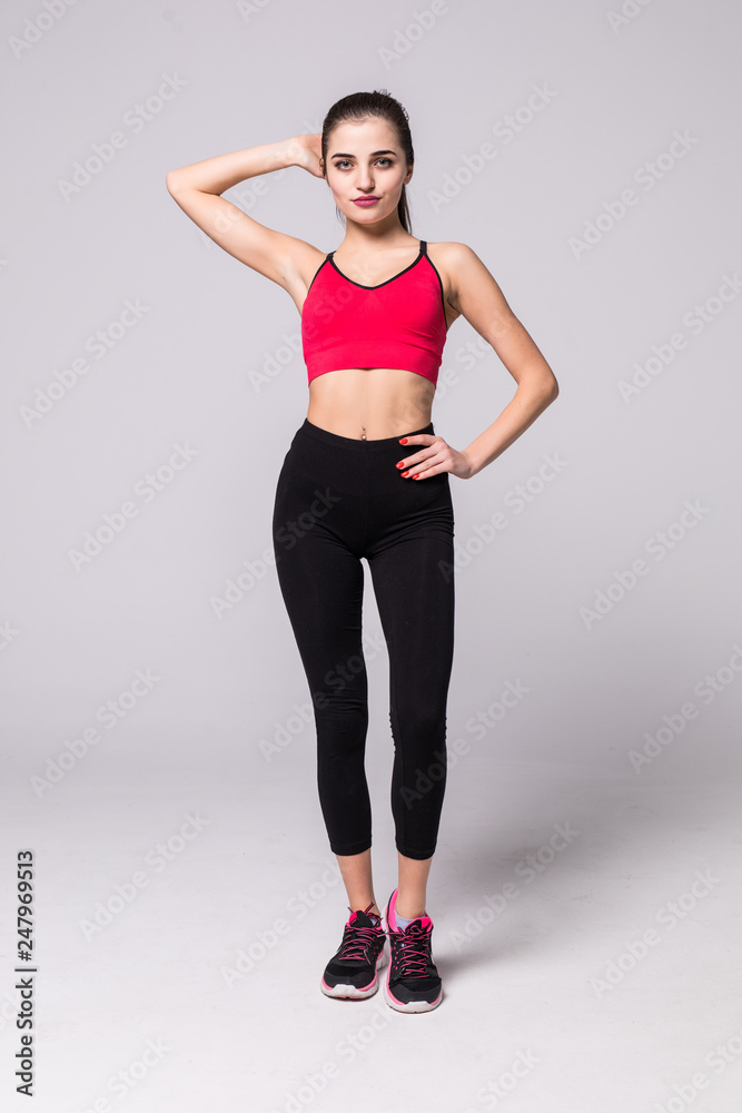 Young fit woman in sports outfit isolated on white background Young fit woman in sports outfit isolated on white background