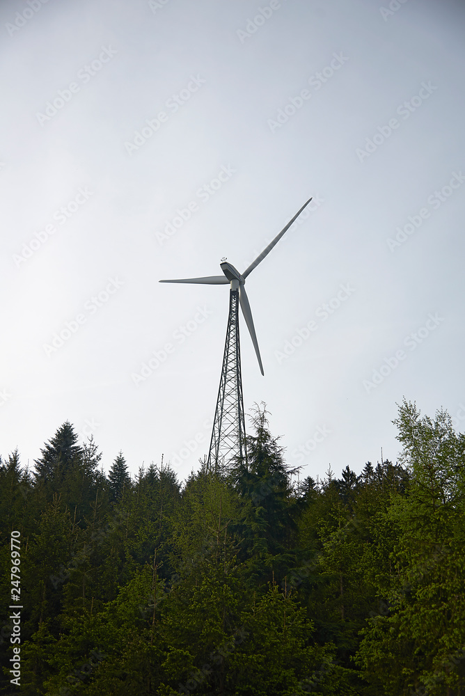 Alternative clean energy is a must these days. Here we see wind parks with many wind turbines in a landscape Alternative clean energy is a must these days. Here we see wind parks with many wind turbines in a landscape