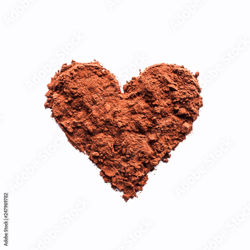 Cocoa powder or coffee in the shape of a heart. Concept- love, recipes, menus, preparation of drinks. Empty space for text or description. Isolated on white.