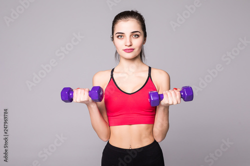 Fitness young woman working out with dumbbell isolated on white background
