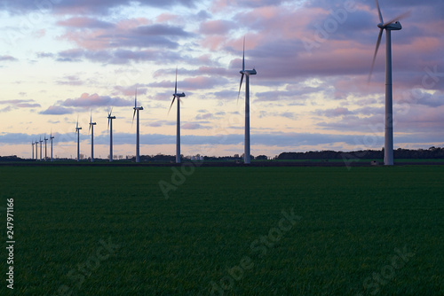 Alternative clean energy is a must these days. Here we see wind parks with many wind turbines in a landscape
