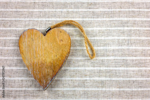  Decorative hearts on wood . Fabric background.