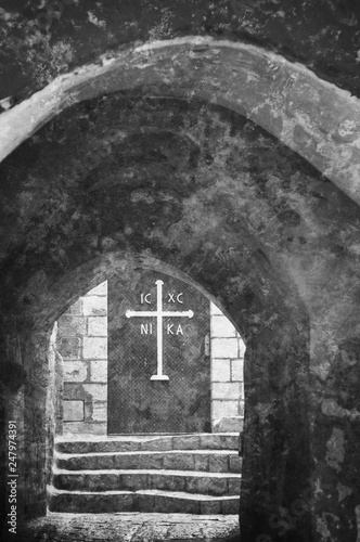 View on the door of St Michael monastery through the archway in Old Jaffa (Tel Aviv-Yafo, Israel). Retro aged photo with scratches. Black and white.
