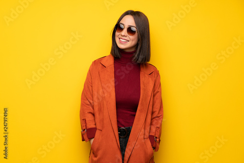 Young woman with coat with glasses and happy © luismolinero